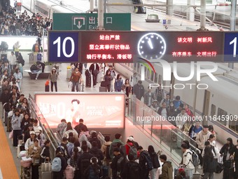 Passengers exit Nanjing Railway Station in Jiangsu province, China, on October 7, 2024. (