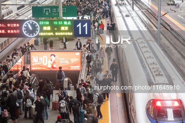 Passengers exit Nanjing Railway Station in Jiangsu province, China, on October 7, 2024. 