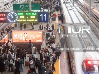 Passengers exit Nanjing Railway Station in Jiangsu province, China, on October 7, 2024. (