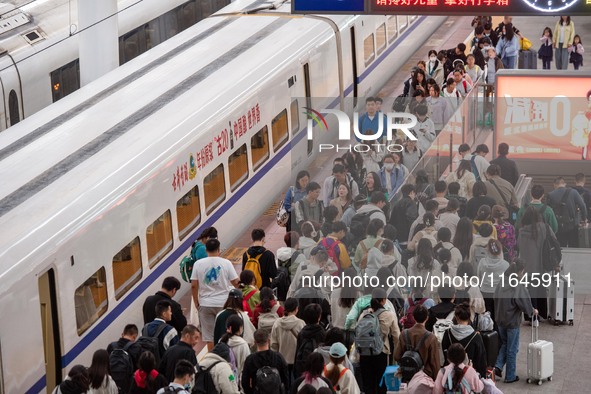 Passengers exit Nanjing Railway Station in Jiangsu province, China, on October 7, 2024. 