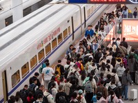 Passengers exit Nanjing Railway Station in Jiangsu province, China, on October 7, 2024. (