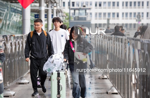 Passengers exit Nanjing Railway Station in Jiangsu province, China, on October 7, 2024. 