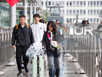 Passengers exit Nanjing Railway Station in Jiangsu province, China, on October 7, 2024. (