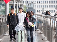 Passengers exit Nanjing Railway Station in Jiangsu province, China, on October 7, 2024. (