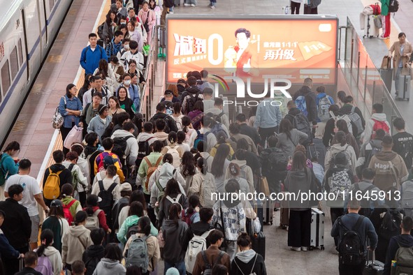 Passengers exit Nanjing Railway Station in Jiangsu province, China, on October 7, 2024. 