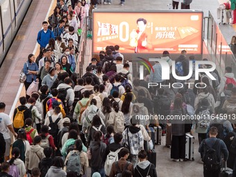 Passengers exit Nanjing Railway Station in Jiangsu province, China, on October 7, 2024. (