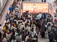 Passengers exit Nanjing Railway Station in Jiangsu province, China, on October 7, 2024. (