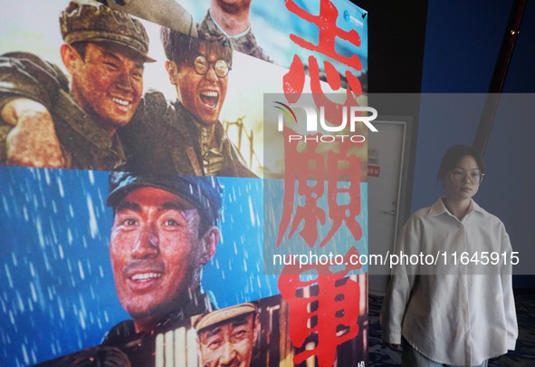 Visitors walk past a poster of the 2024 National Day movie at a cinema in Hangzhou, China, on October 7, 2024. 