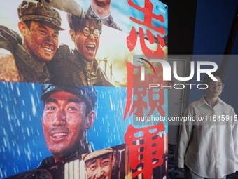 Visitors walk past a poster of the 2024 National Day movie at a cinema in Hangzhou, China, on October 7, 2024. (