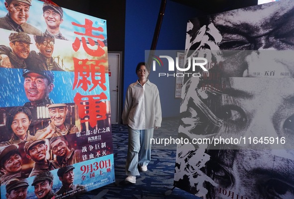 Visitors walk past a poster of the 2024 National Day movie at a cinema in Hangzhou, China, on October 7, 2024. 