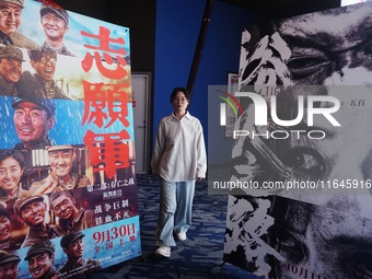 Visitors walk past a poster of the 2024 National Day movie at a cinema in Hangzhou, China, on October 7, 2024. (