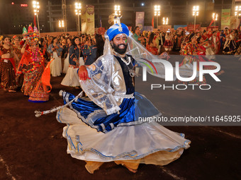 Participants perform 'Garba' during the Dainik Bhaskar Abhivyakti 'Garba Mahotsav' on the occasion of the Navratri festival in Jaipur, Rajas...