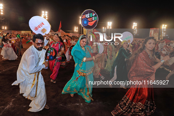 Participants perform 'Garba' during the Dainik Bhaskar Abhivyakti 'Garba Mahotsav' on the occasion of the Navratri festival in Jaipur, Rajas...