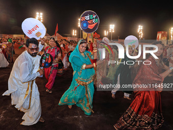 Participants perform 'Garba' during the Dainik Bhaskar Abhivyakti 'Garba Mahotsav' on the occasion of the Navratri festival in Jaipur, Rajas...