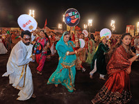 Participants perform 'Garba' during the Dainik Bhaskar Abhivyakti 'Garba Mahotsav' on the occasion of the Navratri festival in Jaipur, Rajas...