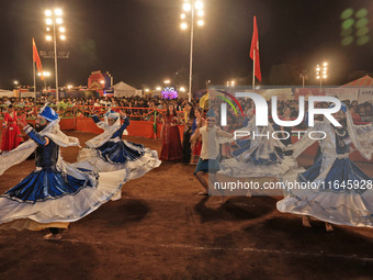 Participants perform 'Garba' during the Dainik Bhaskar Abhivyakti 'Garba Mahotsav' on the occasion of the Navratri festival in Jaipur, Rajas...