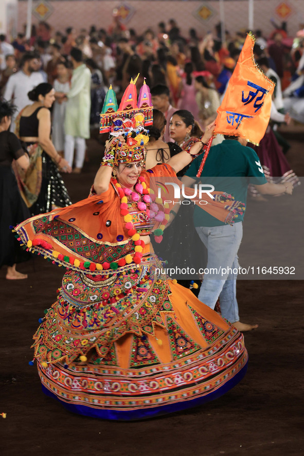 A participant performs 'Garba' during the Dainik Bhaskar Abhivyakti 'Garba Mahotsav' on the occasion of the Navratri festival in Jaipur, Raj...