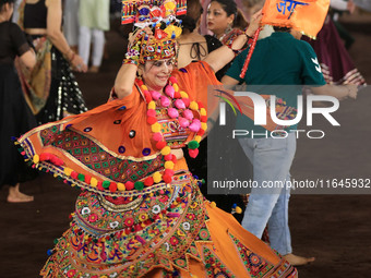 A participant performs 'Garba' during the Dainik Bhaskar Abhivyakti 'Garba Mahotsav' on the occasion of the Navratri festival in Jaipur, Raj...