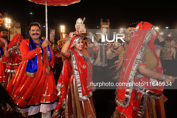 Participants perform 'Garba' during the Dainik Bhaskar Abhivyakti 'Garba Mahotsav' on the occasion of the Navratri festival in Jaipur, Rajas...