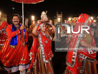 Participants perform 'Garba' during the Dainik Bhaskar Abhivyakti 'Garba Mahotsav' on the occasion of the Navratri festival in Jaipur, Rajas...