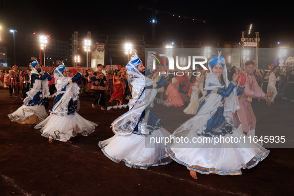 Participants perform 'Garba' during the Dainik Bhaskar Abhivyakti 'Garba Mahotsav' on the occasion of the Navratri festival in Jaipur, Rajas...