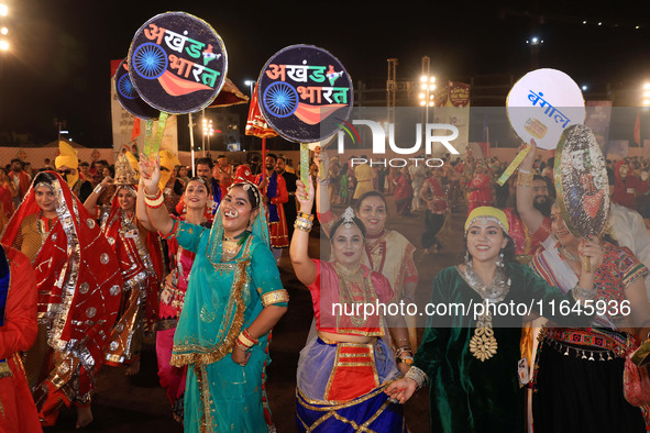 Participants perform 'Garba' during the Dainik Bhaskar Abhivyakti 'Garba Mahotsav' on the occasion of the Navratri festival in Jaipur, Rajas...