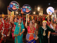 Participants perform 'Garba' during the Dainik Bhaskar Abhivyakti 'Garba Mahotsav' on the occasion of the Navratri festival in Jaipur, Rajas...