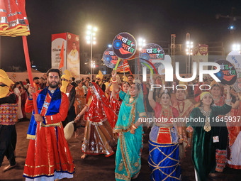 Participants perform 'Garba' during the Dainik Bhaskar Abhivyakti 'Garba Mahotsav' on the occasion of the Navratri festival in Jaipur, Rajas...