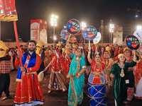 Participants perform 'Garba' during the Dainik Bhaskar Abhivyakti 'Garba Mahotsav' on the occasion of the Navratri festival in Jaipur, Rajas...