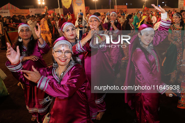 Participants perform 'Garba' during the Dainik Bhaskar Abhivyakti 'Garba Mahotsav' on the occasion of the Navratri festival in Jaipur, Rajas...