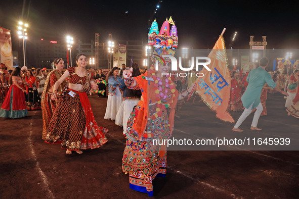 Participants perform 'Garba' during the Dainik Bhaskar Abhivyakti 'Garba Mahotsav' on the occasion of the Navratri festival in Jaipur, Rajas...