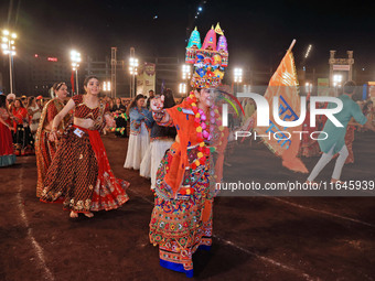 Participants perform 'Garba' during the Dainik Bhaskar Abhivyakti 'Garba Mahotsav' on the occasion of the Navratri festival in Jaipur, Rajas...