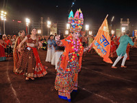 Participants perform 'Garba' during the Dainik Bhaskar Abhivyakti 'Garba Mahotsav' on the occasion of the Navratri festival in Jaipur, Rajas...