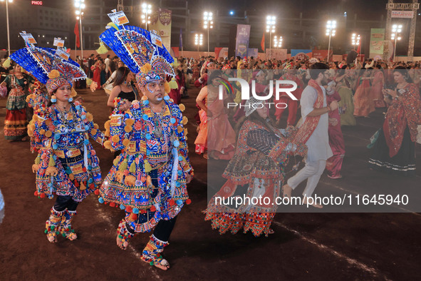 Participants perform 'Garba' during the Dainik Bhaskar Abhivyakti 'Garba Mahotsav' on the occasion of the Navratri festival in Jaipur, Rajas...