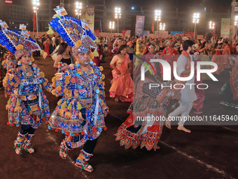 Participants perform 'Garba' during the Dainik Bhaskar Abhivyakti 'Garba Mahotsav' on the occasion of the Navratri festival in Jaipur, Rajas...