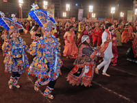 Participants perform 'Garba' during the Dainik Bhaskar Abhivyakti 'Garba Mahotsav' on the occasion of the Navratri festival in Jaipur, Rajas...