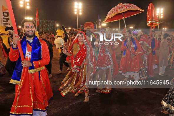 Participants perform 'Garba' during the Dainik Bhaskar Abhivyakti 'Garba Mahotsav' on the occasion of the Navratri festival in Jaipur, Rajas...