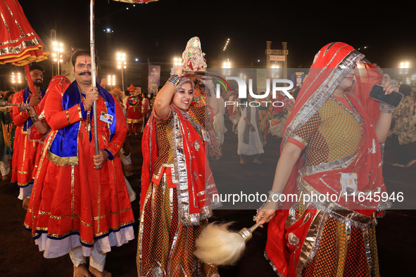 Participants perform 'Garba' during the Dainik Bhaskar Abhivyakti 'Garba Mahotsav' on the occasion of the Navratri festival in Jaipur, Rajas...