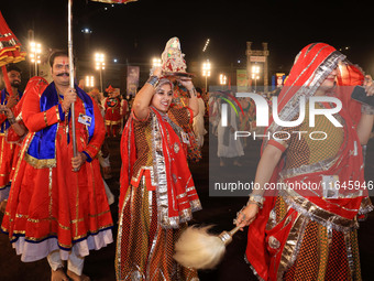 Participants perform 'Garba' during the Dainik Bhaskar Abhivyakti 'Garba Mahotsav' on the occasion of the Navratri festival in Jaipur, Rajas...