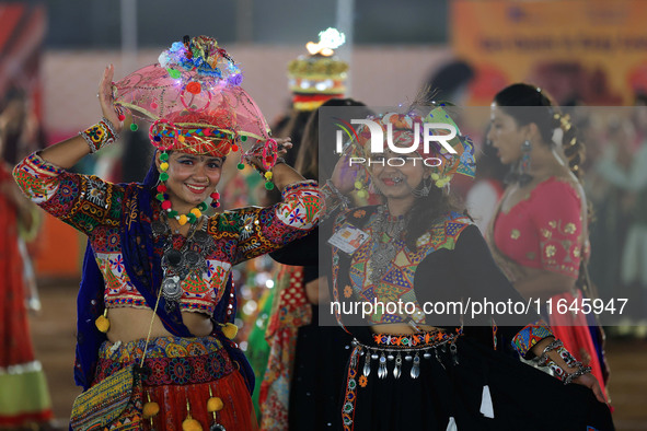 Participants perform 'Garba' during the Dainik Bhaskar Abhivyakti 'Garba Mahotsav' on the occasion of the Navratri festival in Jaipur, Rajas...