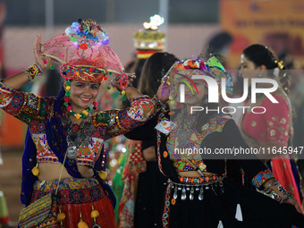 Participants perform 'Garba' during the Dainik Bhaskar Abhivyakti 'Garba Mahotsav' on the occasion of the Navratri festival in Jaipur, Rajas...