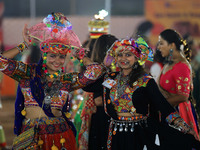 Participants perform 'Garba' during the Dainik Bhaskar Abhivyakti 'Garba Mahotsav' on the occasion of the Navratri festival in Jaipur, Rajas...