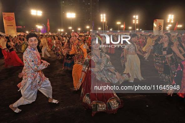 Participants perform 'Garba' during the Dainik Bhaskar Abhivyakti 'Garba Mahotsav' on the occasion of the Navratri festival in Jaipur, Rajas...