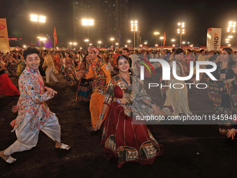 Participants perform 'Garba' during the Dainik Bhaskar Abhivyakti 'Garba Mahotsav' on the occasion of the Navratri festival in Jaipur, Rajas...