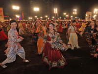 Participants perform 'Garba' during the Dainik Bhaskar Abhivyakti 'Garba Mahotsav' on the occasion of the Navratri festival in Jaipur, Rajas...