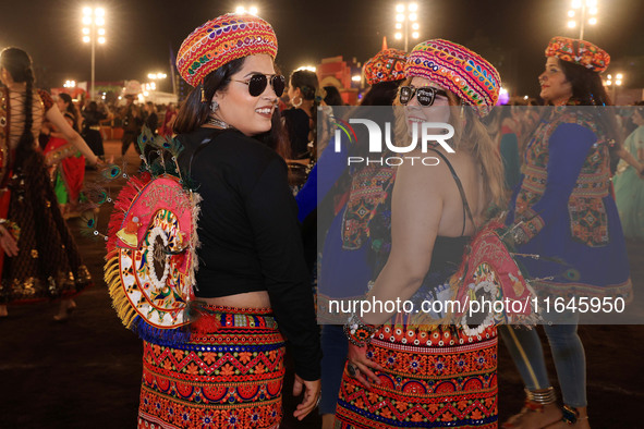 Participants perform 'Garba' during the Dainik Bhaskar Abhivyakti 'Garba Mahotsav' on the occasion of the Navratri festival in Jaipur, Rajas...