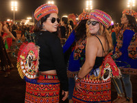 Participants perform 'Garba' during the Dainik Bhaskar Abhivyakti 'Garba Mahotsav' on the occasion of the Navratri festival in Jaipur, Rajas...