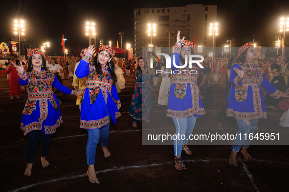 Participants perform 'Garba' during the Dainik Bhaskar Abhivyakti 'Garba Mahotsav' on the occasion of the Navratri festival in Jaipur, Rajas...