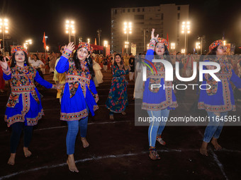 Participants perform 'Garba' during the Dainik Bhaskar Abhivyakti 'Garba Mahotsav' on the occasion of the Navratri festival in Jaipur, Rajas...