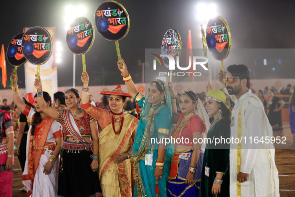 Participants perform 'Garba' during the Dainik Bhaskar Abhivyakti 'Garba Mahotsav' on the occasion of the Navratri festival in Jaipur, Rajas...